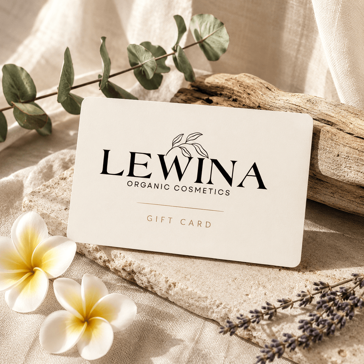 Gift card resting on natural stone surrounded by natural botanicals.