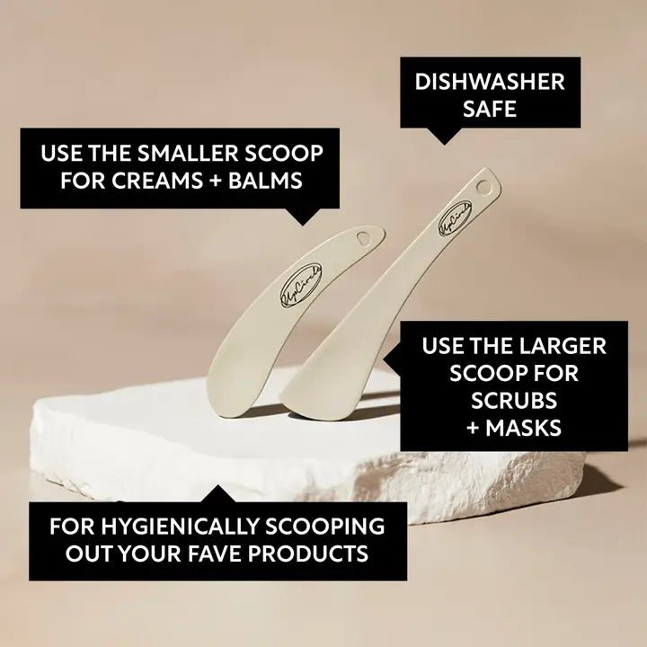 Two reusable cosmetic spatulas on a clean background.