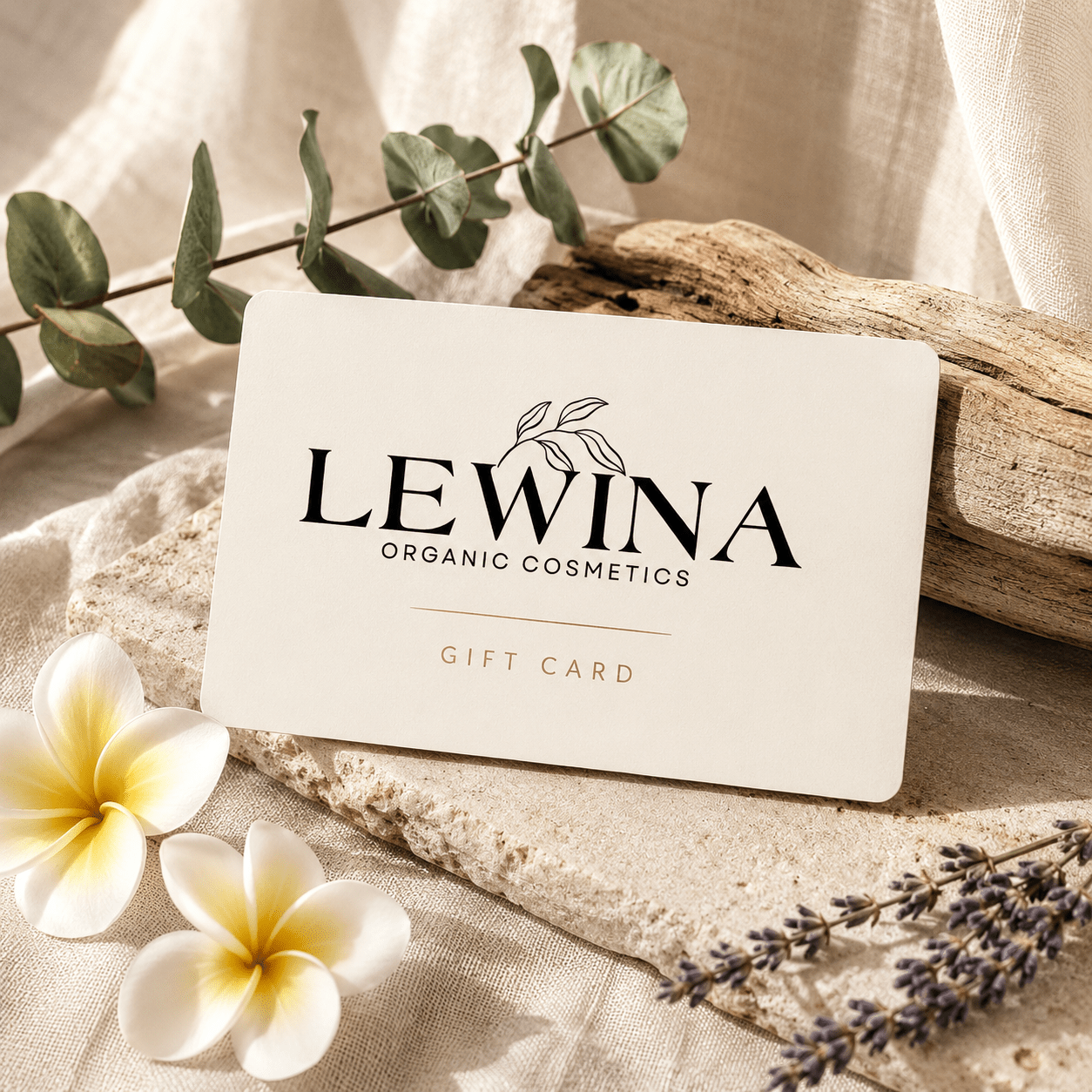 Gift card resting on natural stone surrounded by natural botanicals.