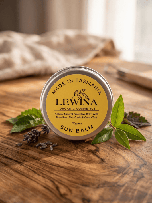 Lewina natural water-free Sun Balm tin on weathered timber with Tasmanian coastal garden styling